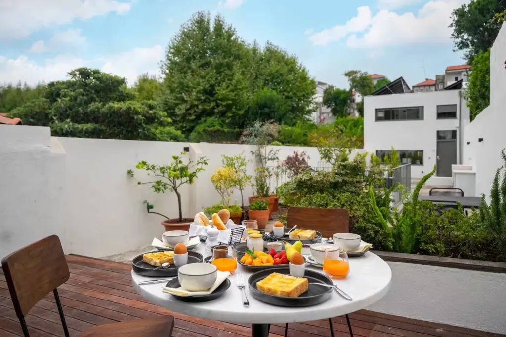 Homemade breakfast with fruit, eggs and cake on the garden terrace at Canto de Luz