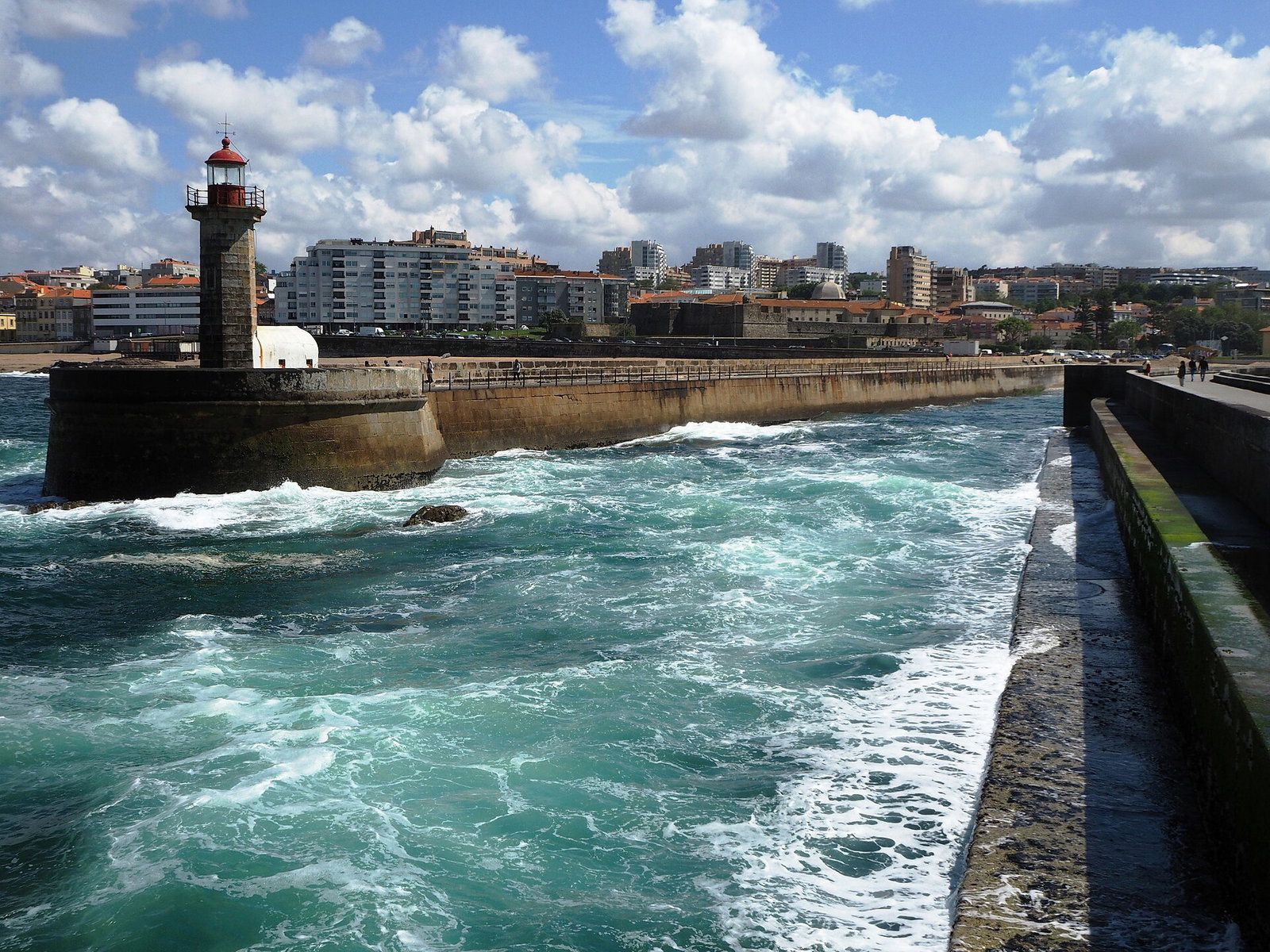 Waves breaking against the Felgueiras lighthouse breakwater at Foz do Douro