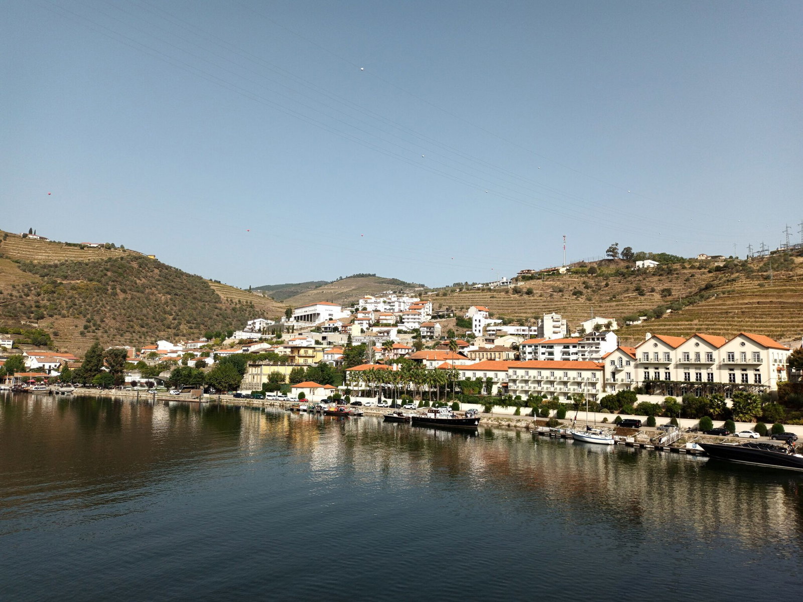 The riverside town of Pinhao on the Douro with terraced vineyards rising behind it