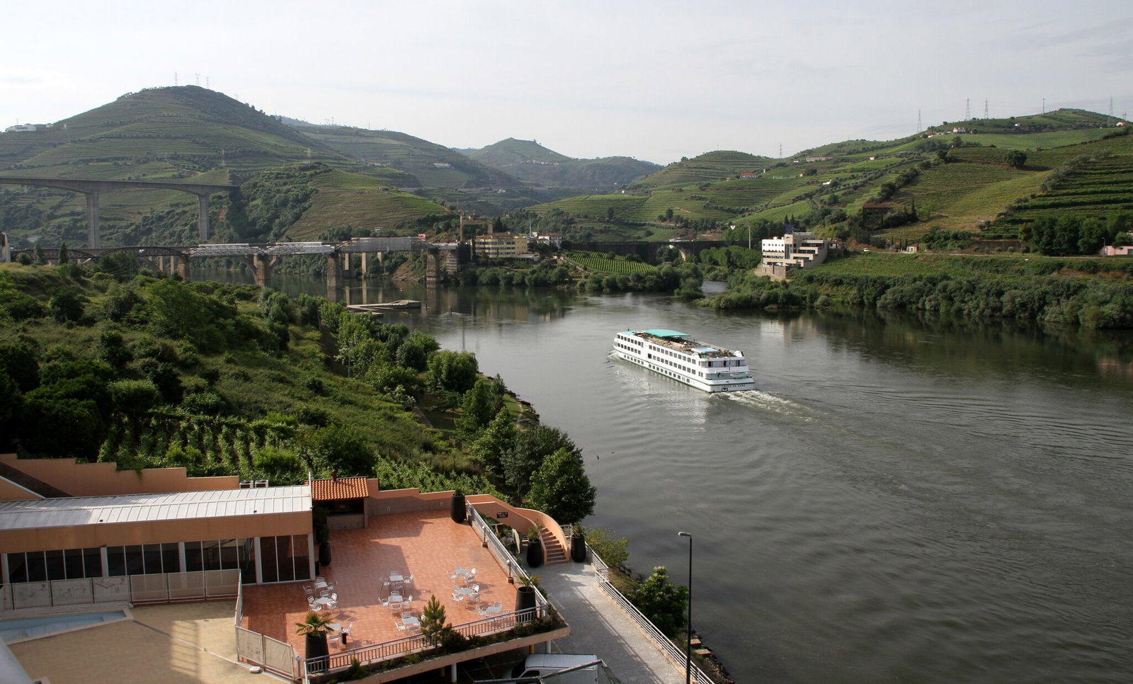 A river cruise boat on the Douro near Peso da Regua with terraced hillsides