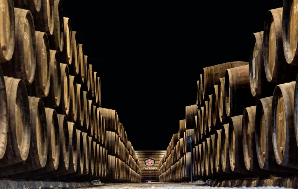 Rows of port wine barrels ageing in a lodge cellar in Vila Nova de Gaia