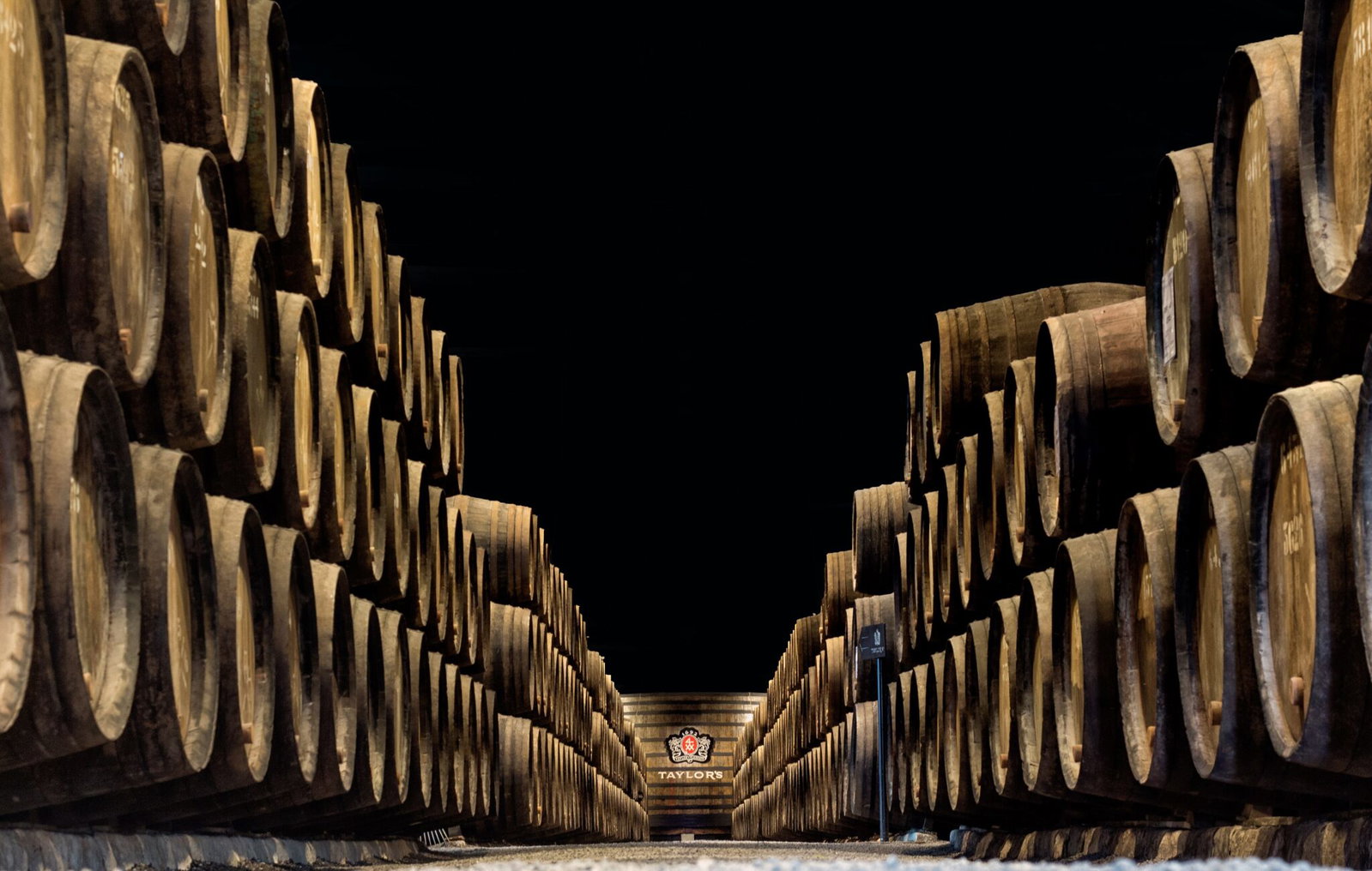 Rows of port wine barrels ageing in a lodge cellar in Vila Nova de Gaia
