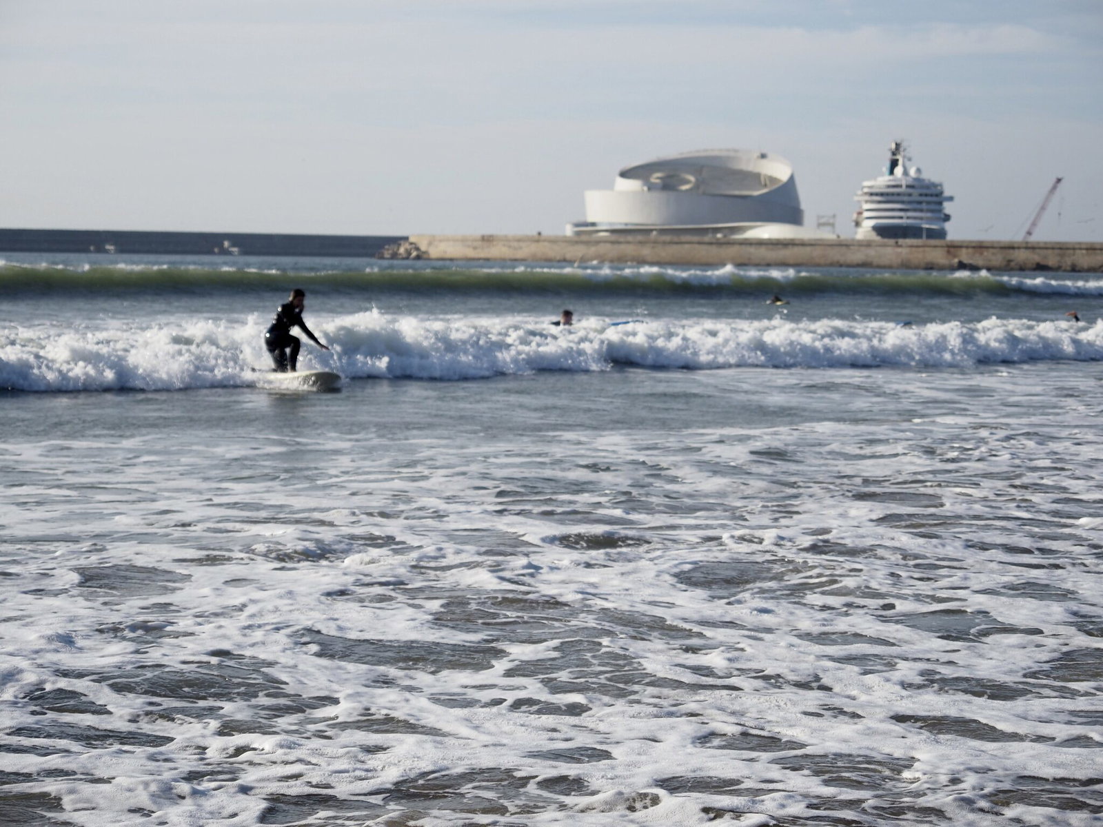 Surfer riding a wave at Matosinhos beach near Porto