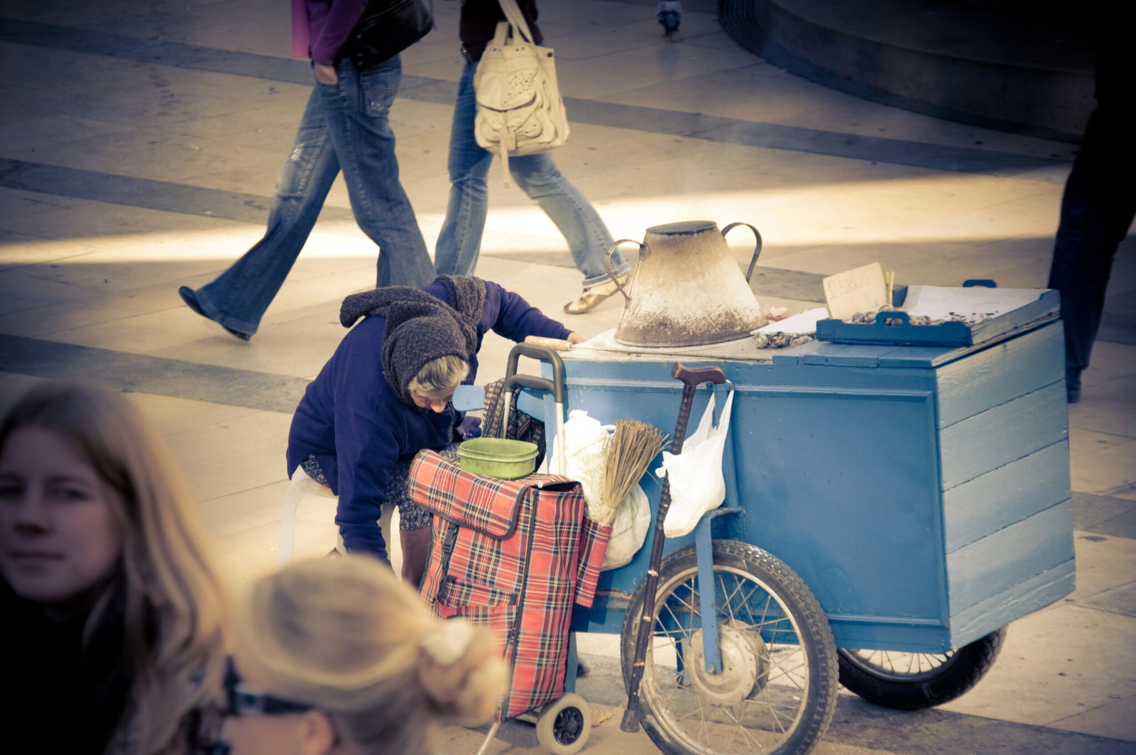 A street seller roasting chestnuts on a traditional cart in Guimaraes, Portugal