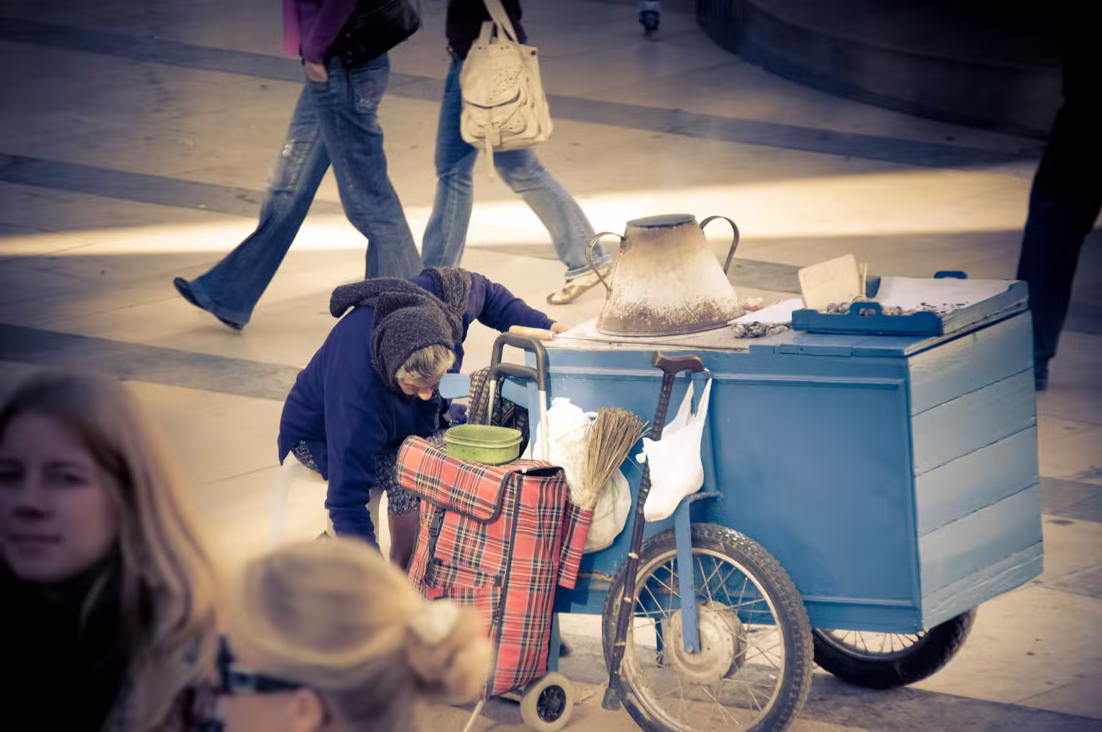 A street seller roasting chestnuts on a traditional cart in Guimaraes, Portugal