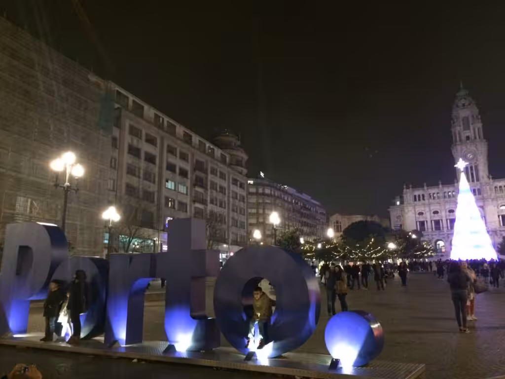 Avenida dos Aliados in Porto at night in the festive season, with the giant Porto letters and the lit Christmas tree in front of City Hall