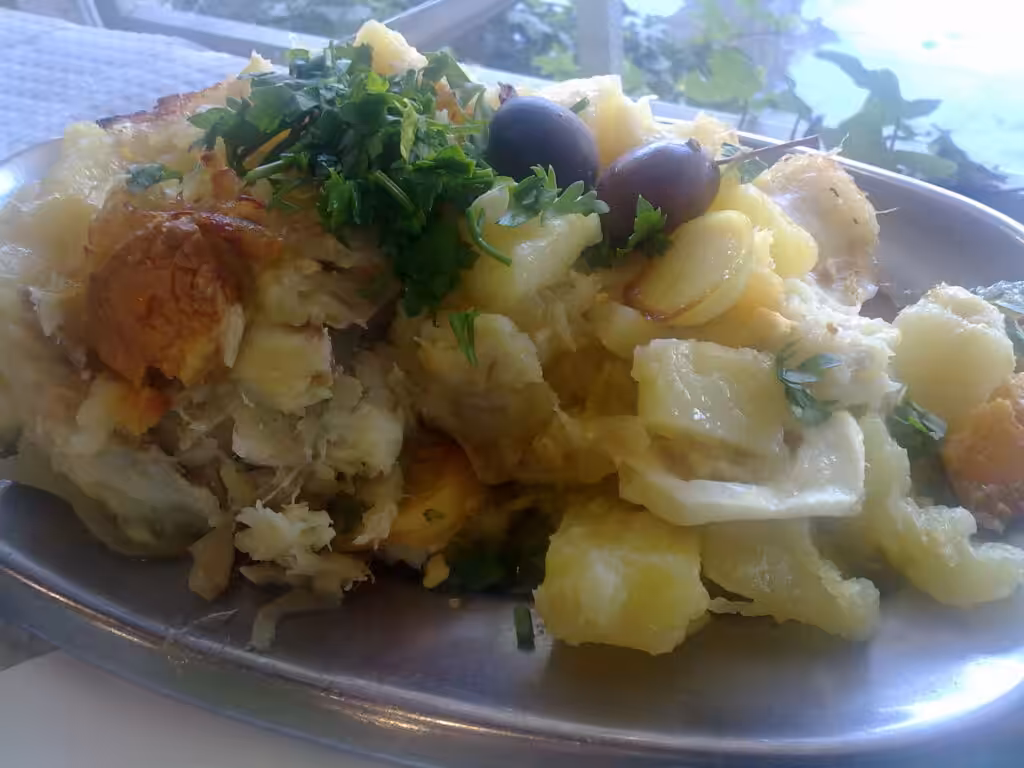 A Portuguese salt cod dish with potatoes, egg, olives and parsley