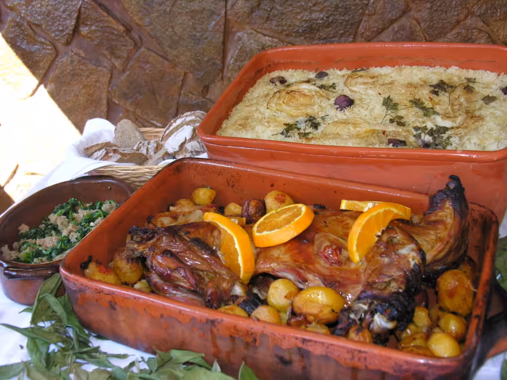 Cabrito assado, Portuguese roast kid with potatoes, served with oven rice and greens