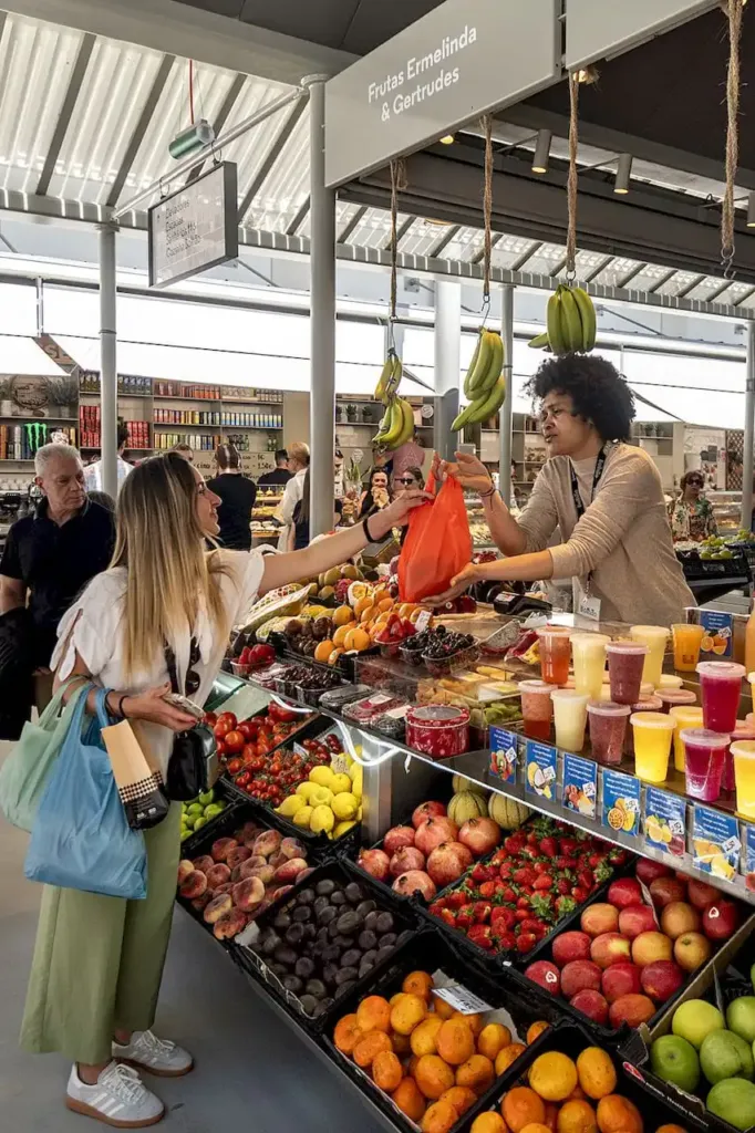 A Canto Cooking market tour stop at a fruit stall inside the Mercado do Bolhao in Porto