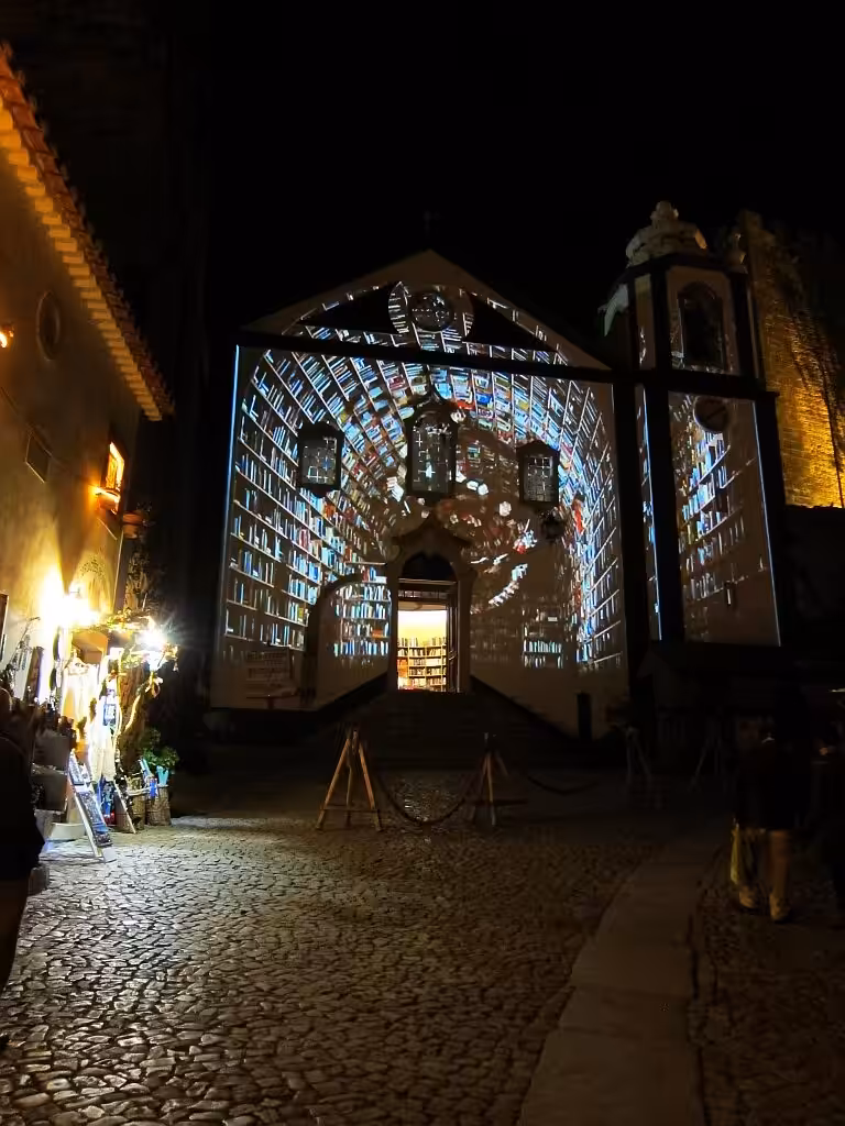 Christmas video mapping projected onto the Santiago church bookshop in Obidos at night