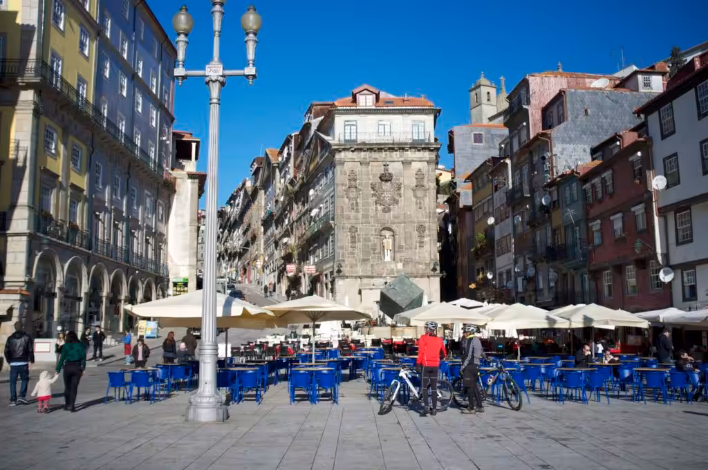 Praca da Ribeira in Porto on a sunny December day, with cafe terraces and old town facades