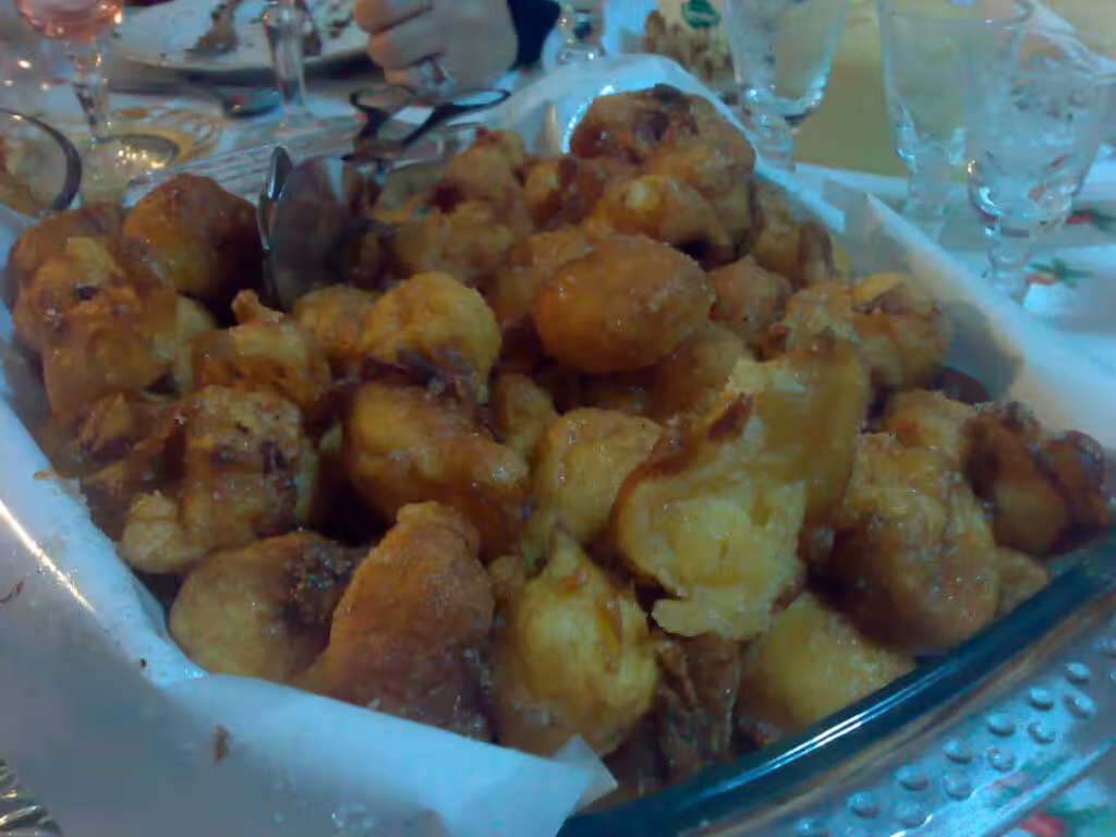 A dish of sonhos, Portuguese Christmas fritters dusted with sugar